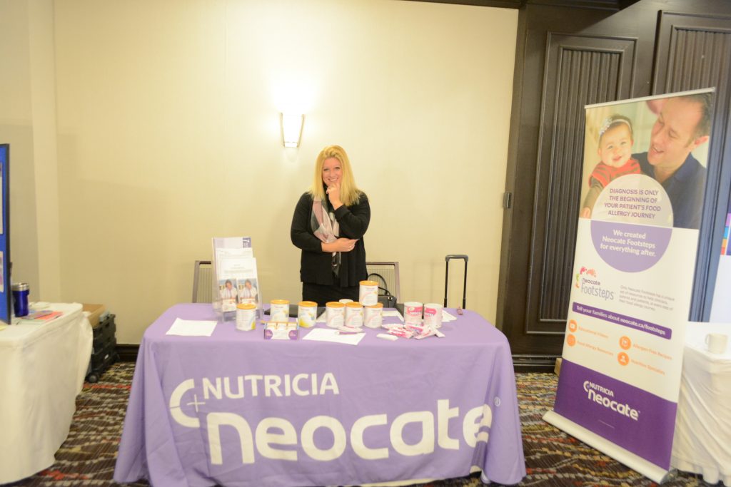 Nutricia Neocate representative smiling at their booth