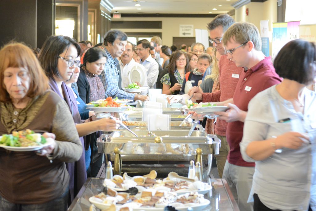 Conference participants getting food at the buffet