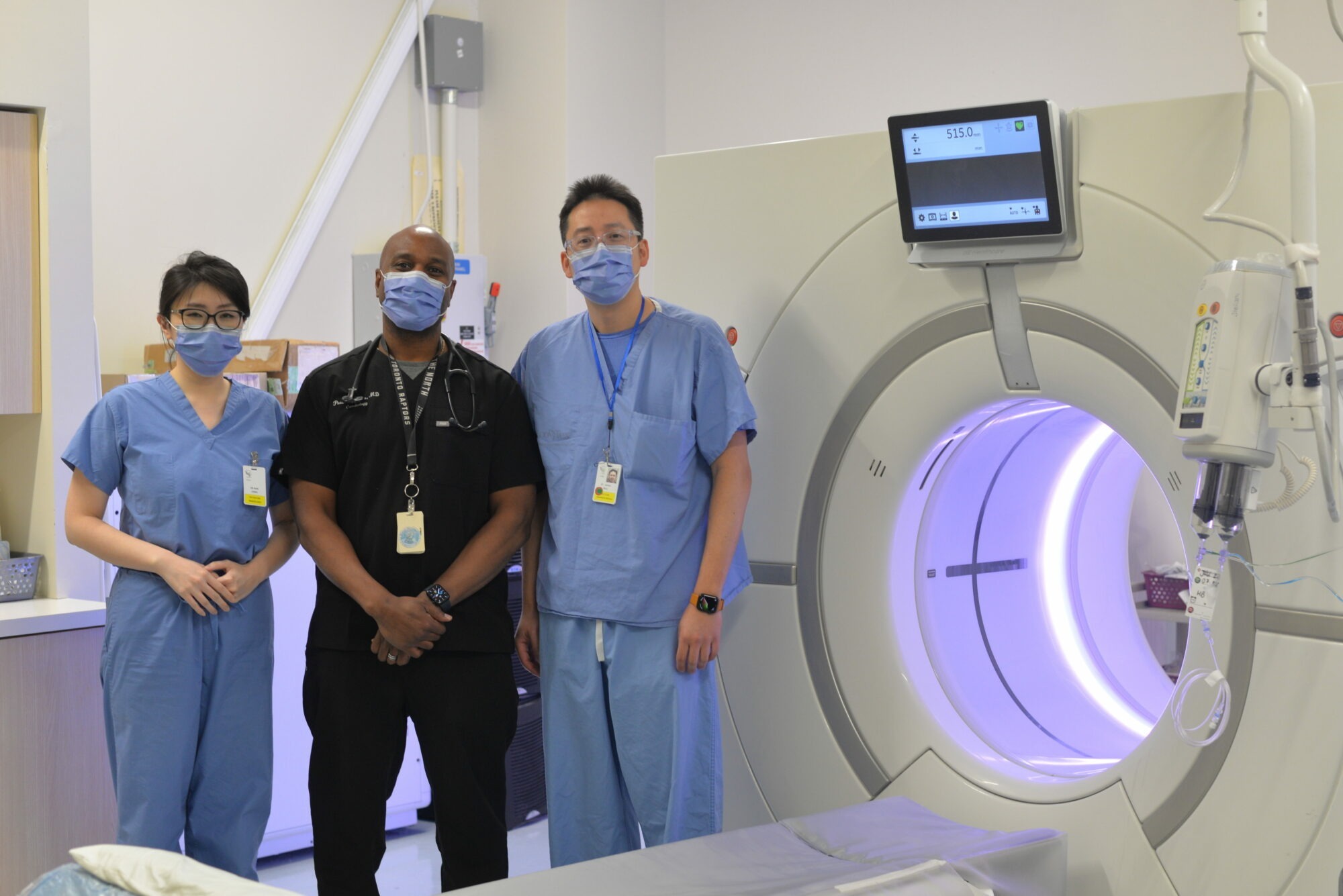 Structural Heart Disease Clinic team in front of machine that performs TAVI CT scans