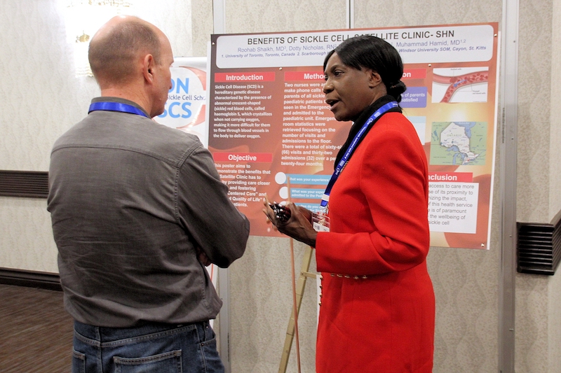 Poster presenter speaking to an attendee