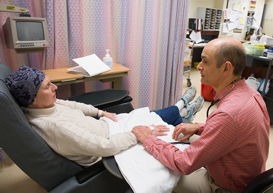 Doctor speaking with patient in oncology clinic