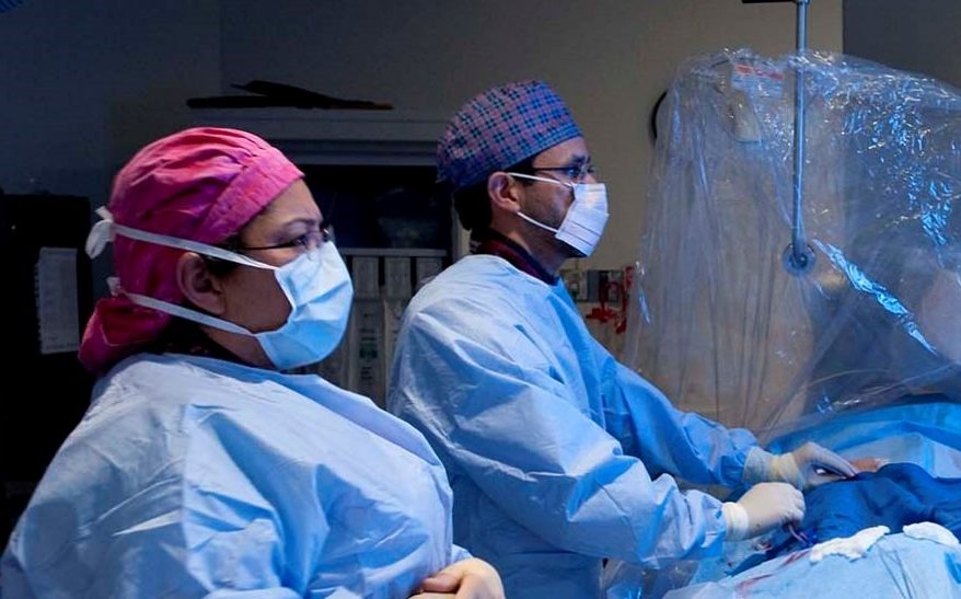 surgeons performing cardiac procedure