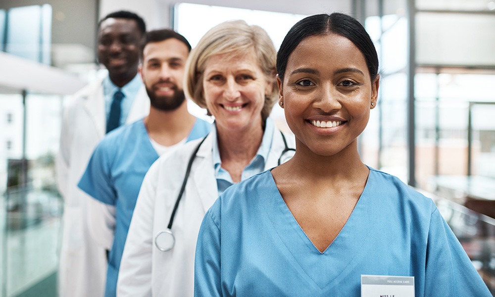 Portrait of a group of medical practitioners standing together in a hospital.