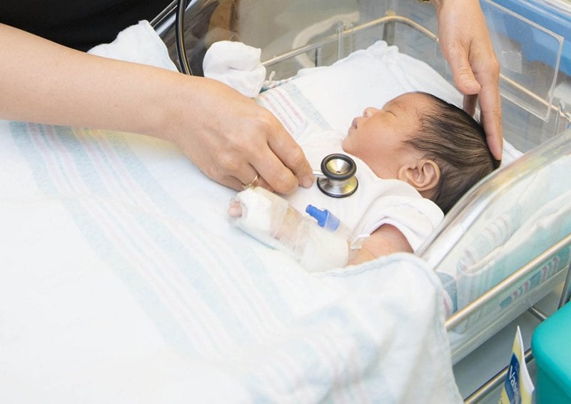 Newborn in incubator in NICU