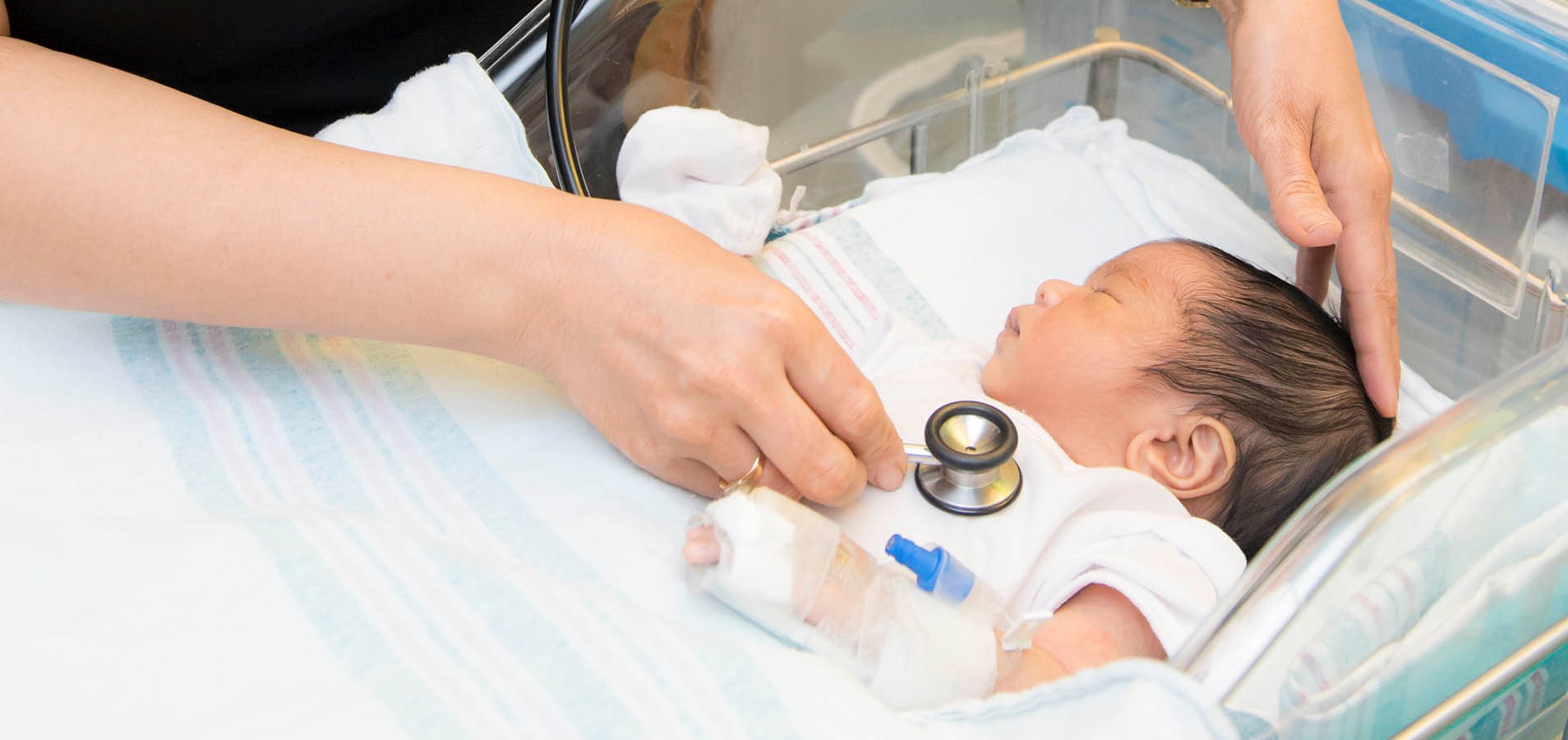 baby having heart checked with stethoscope