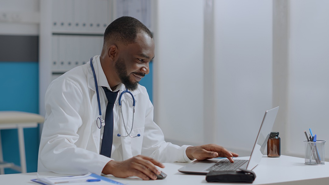 Physician completing eReferral on laptop