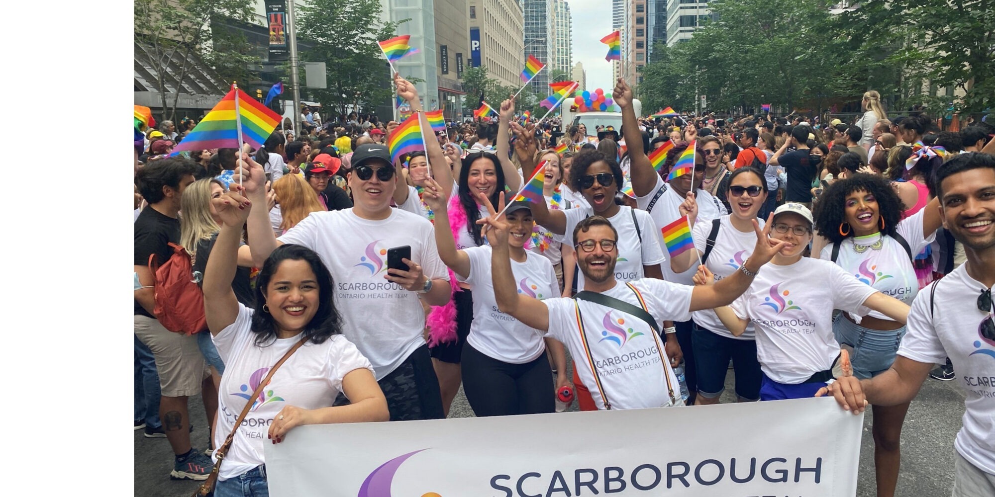 Members of the Scarborough Ontario Health Team (SOHT) hold an SOHT banner at the 2022 Pride Parade in Toronto.