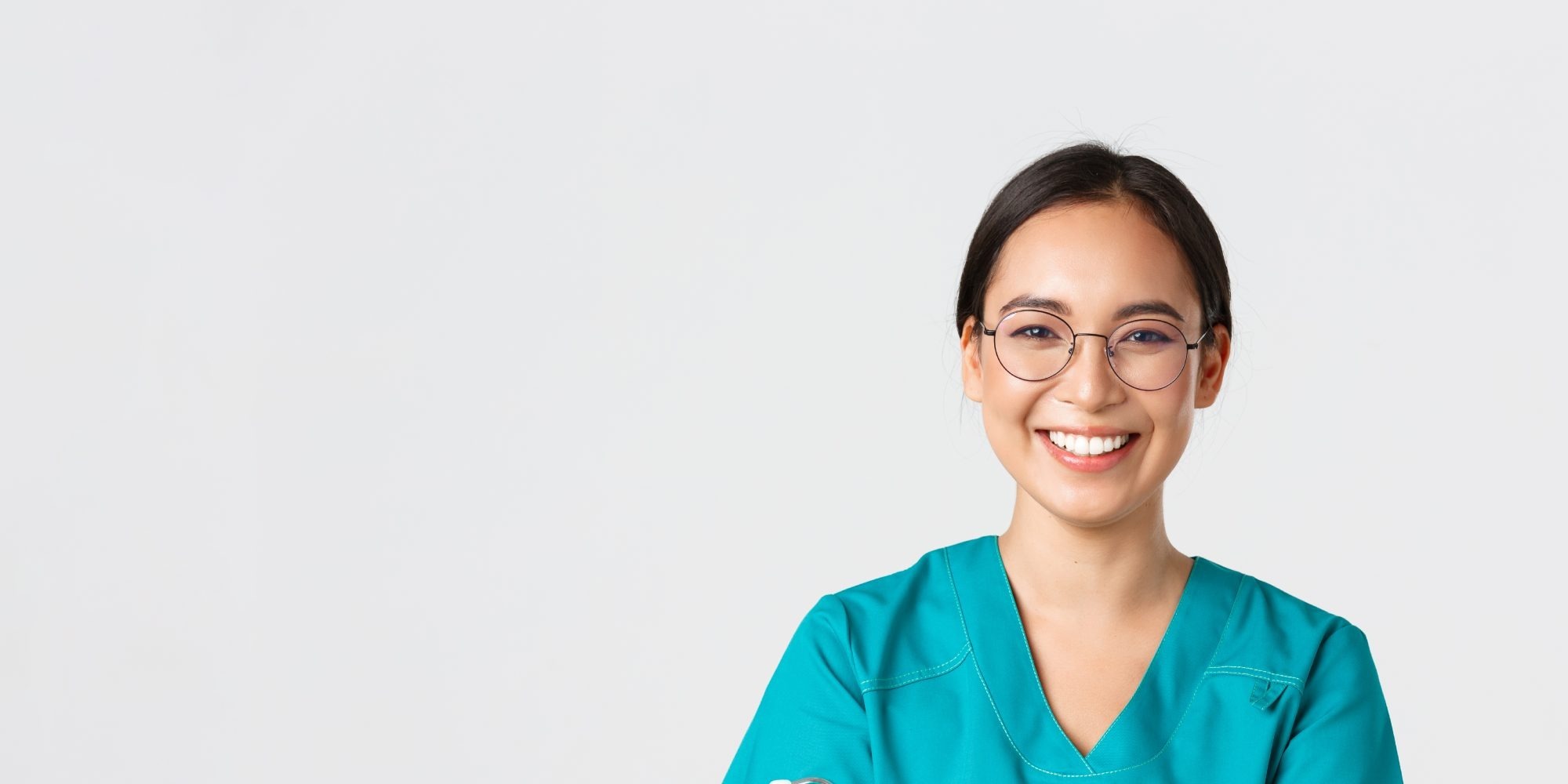 Healthcare worker in scrubs smiling